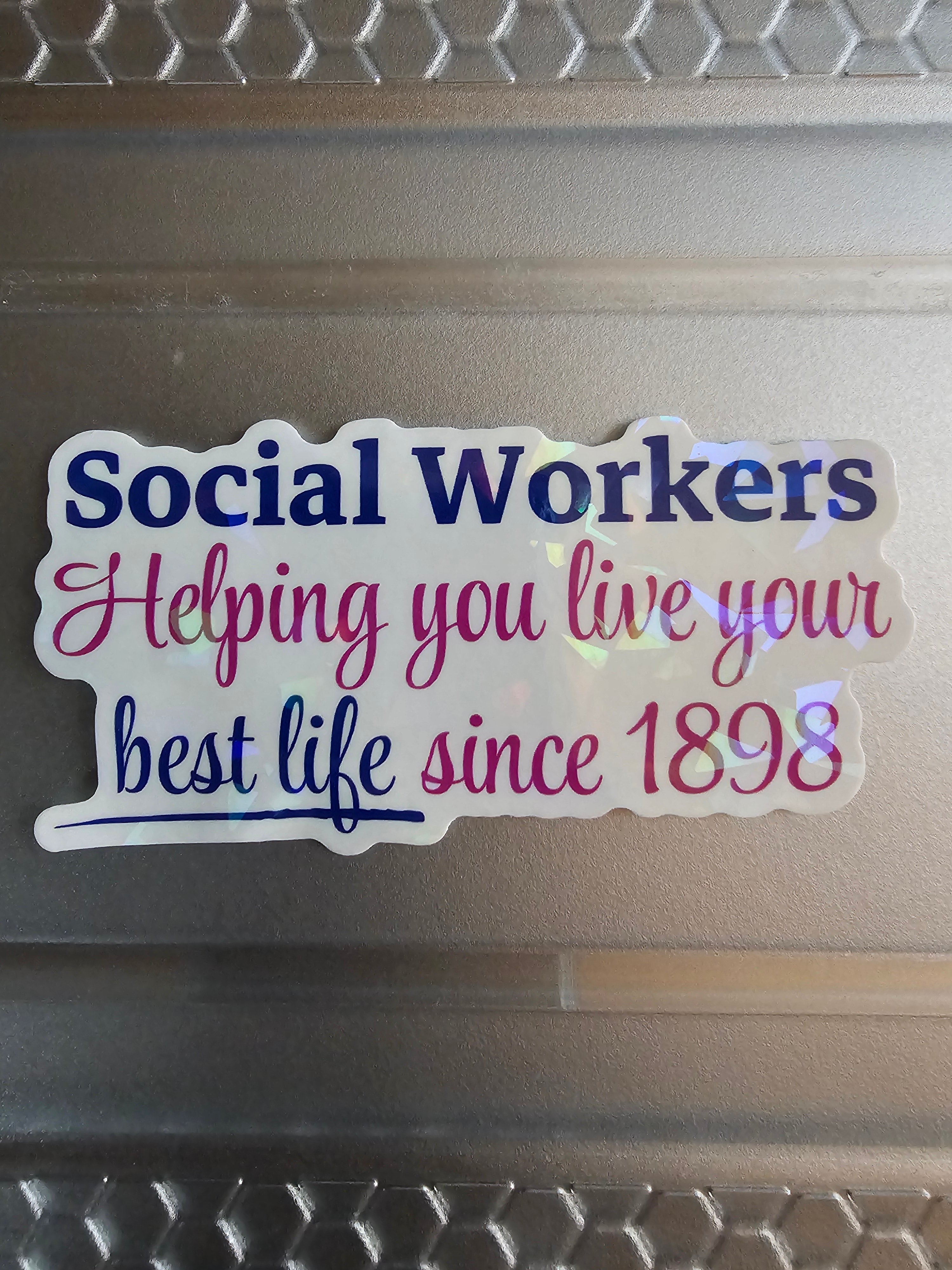 Sticker with text 'Social Workers Helping you live your best life since 1898' on a laptop surface