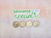 four silver coins arranged in a row on a pink and purple textured background.