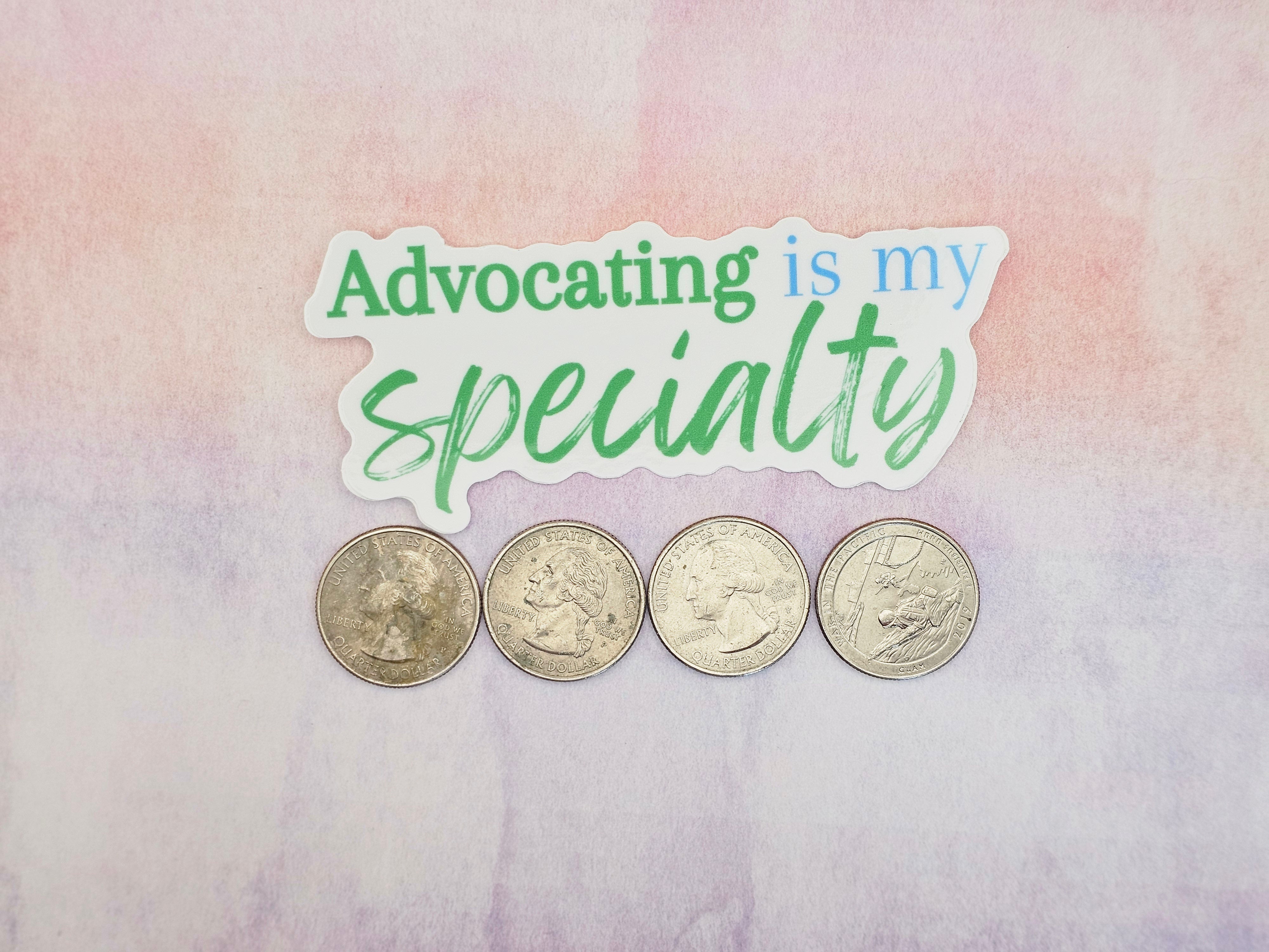 four silver coins arranged in a row on a pink and purple textured background.